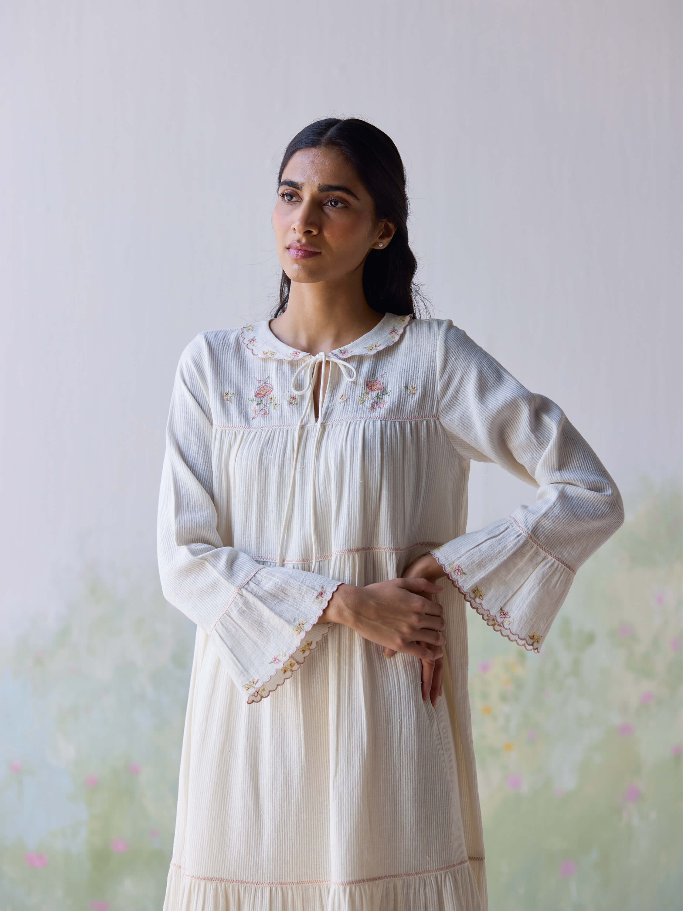 Elegant woman in Adagio Tier Midi Dress with floral embroidery.