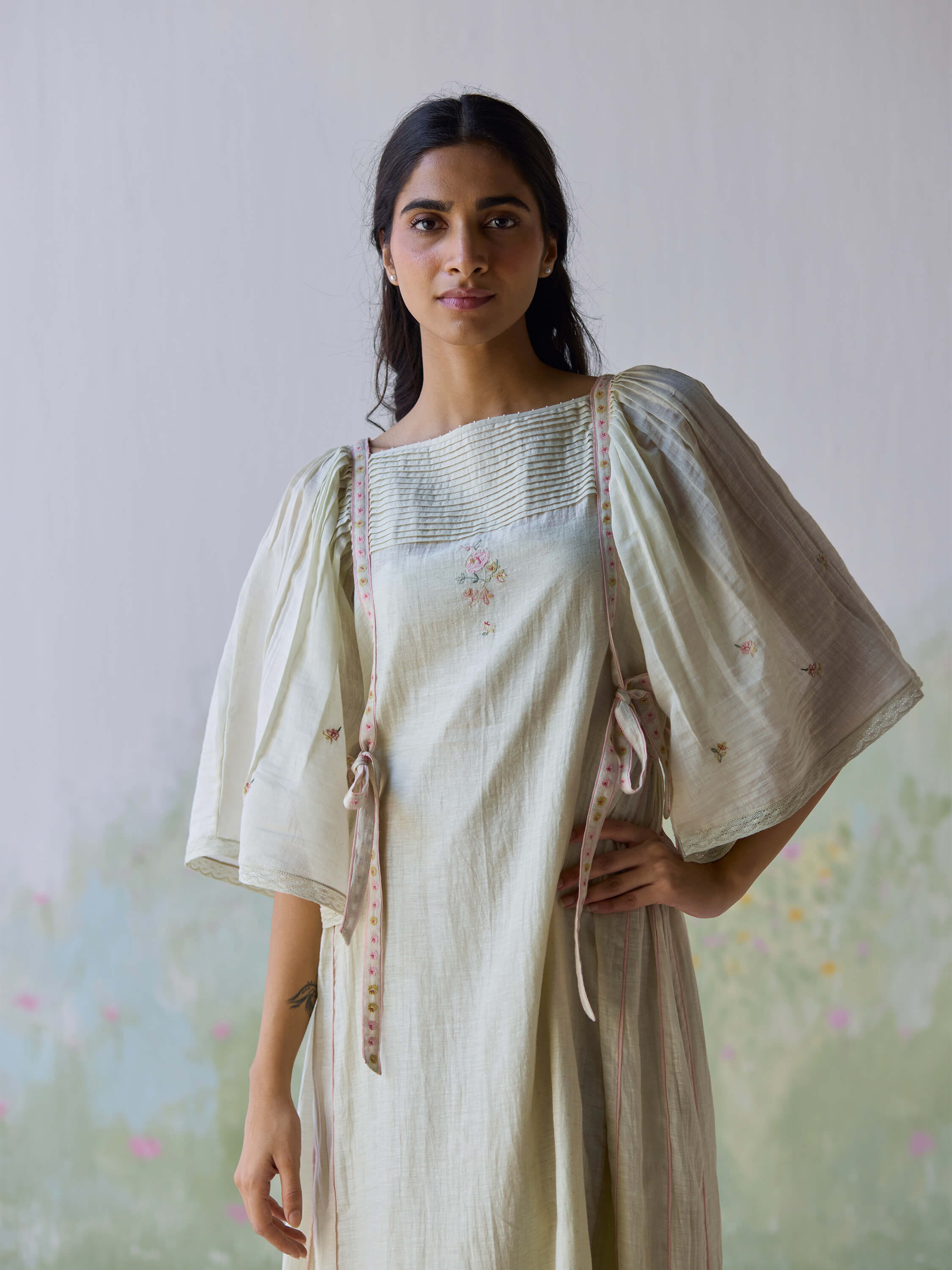 "Amore Midi Dress with elegant puff sleeves and delicate floral embroidery."