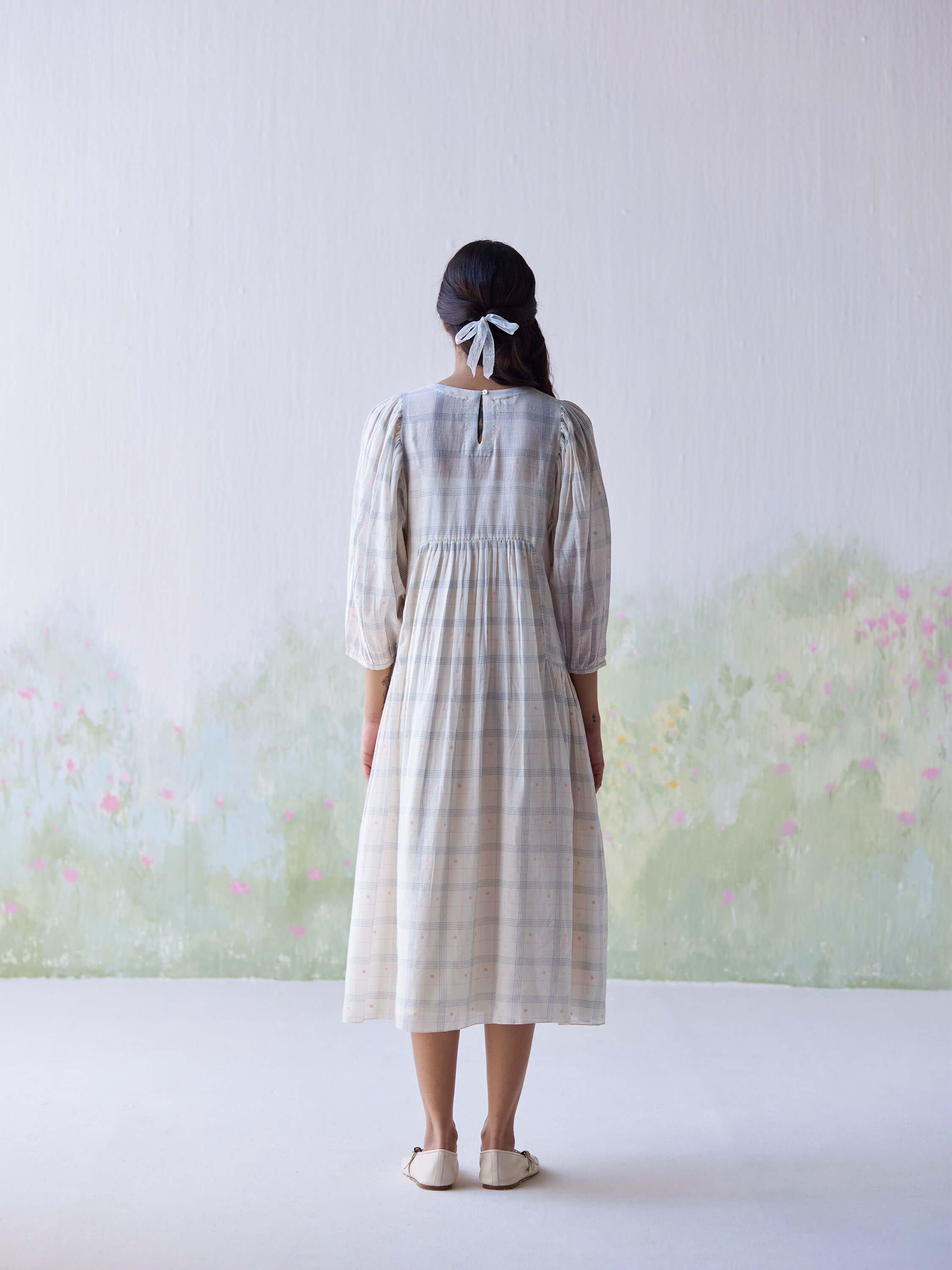 Gentle Days Jamdani Dress, back view, soft colors, floral background.