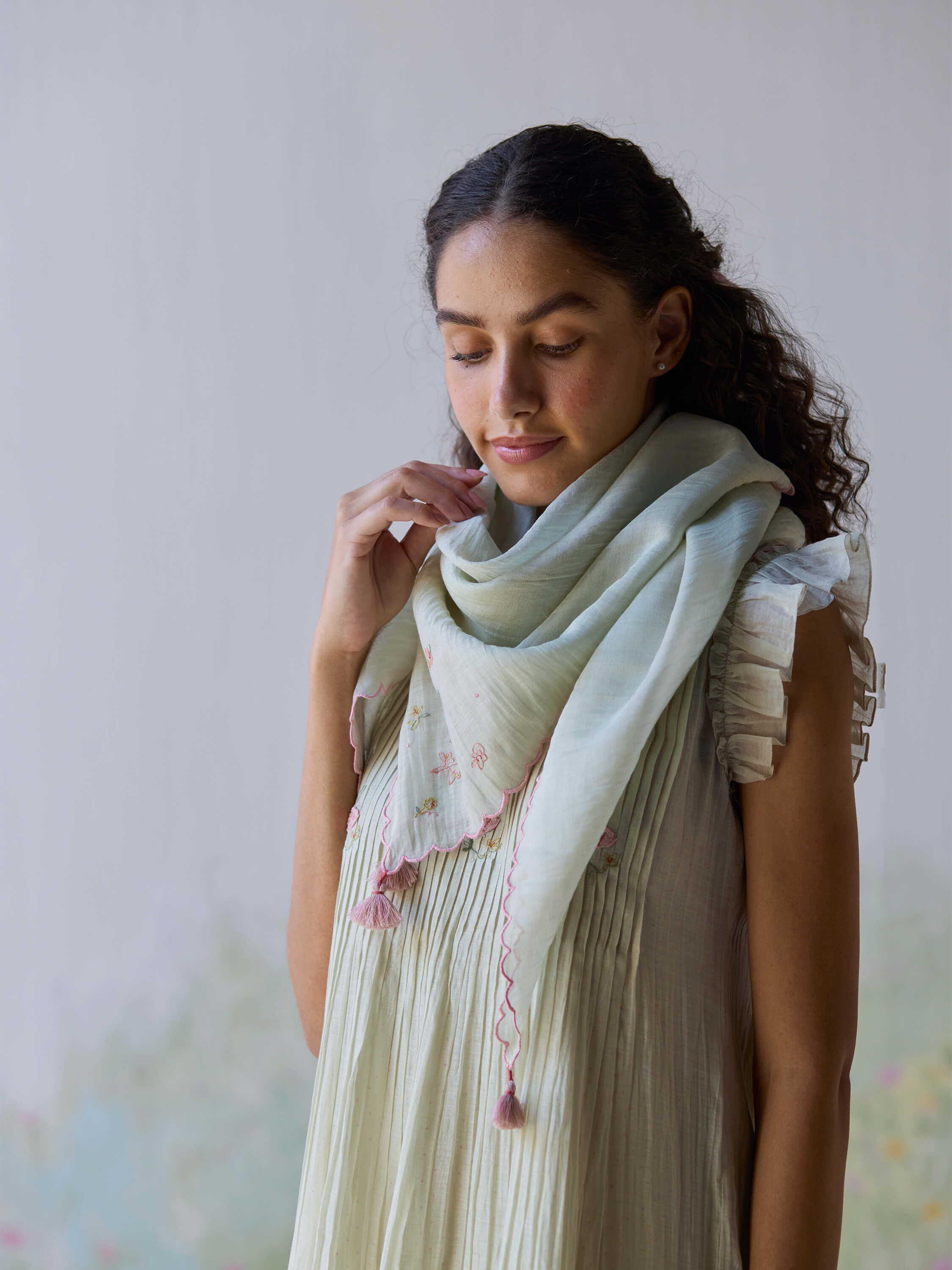Elegant Minty Breeze Scarf styled with floral embroidery and tassels.