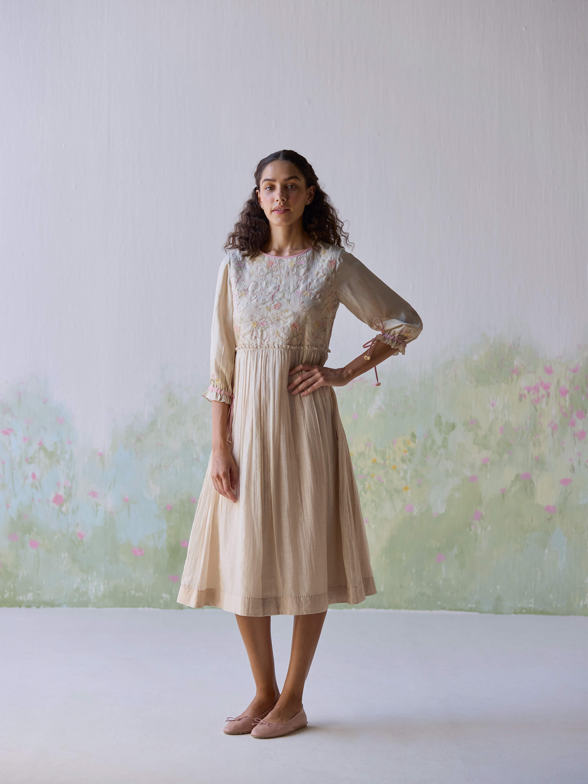 Sonata Embroidered Dress on model against floral background.