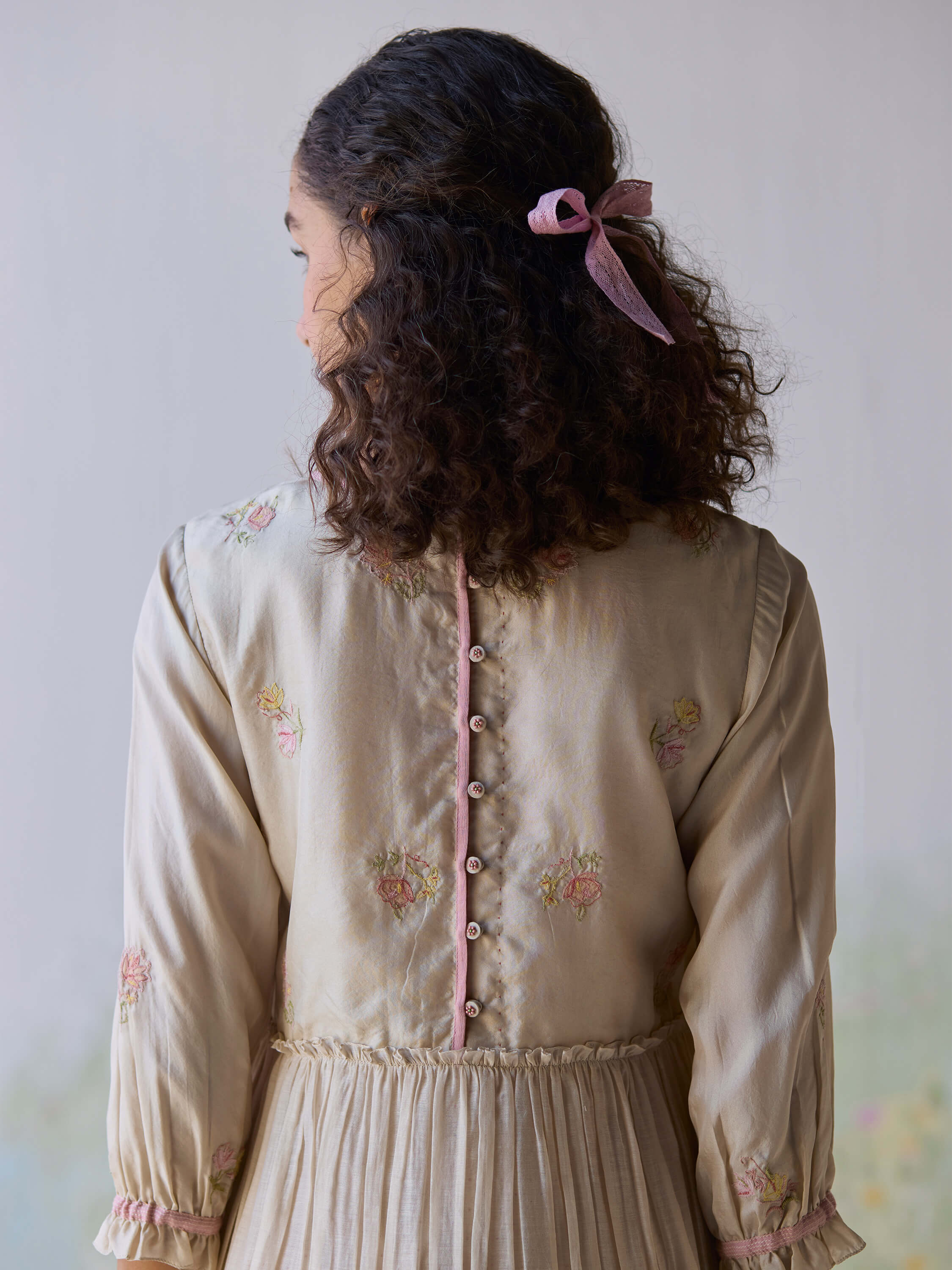 Back view of Sonata Embroidered Dress with floral designs and buttons.