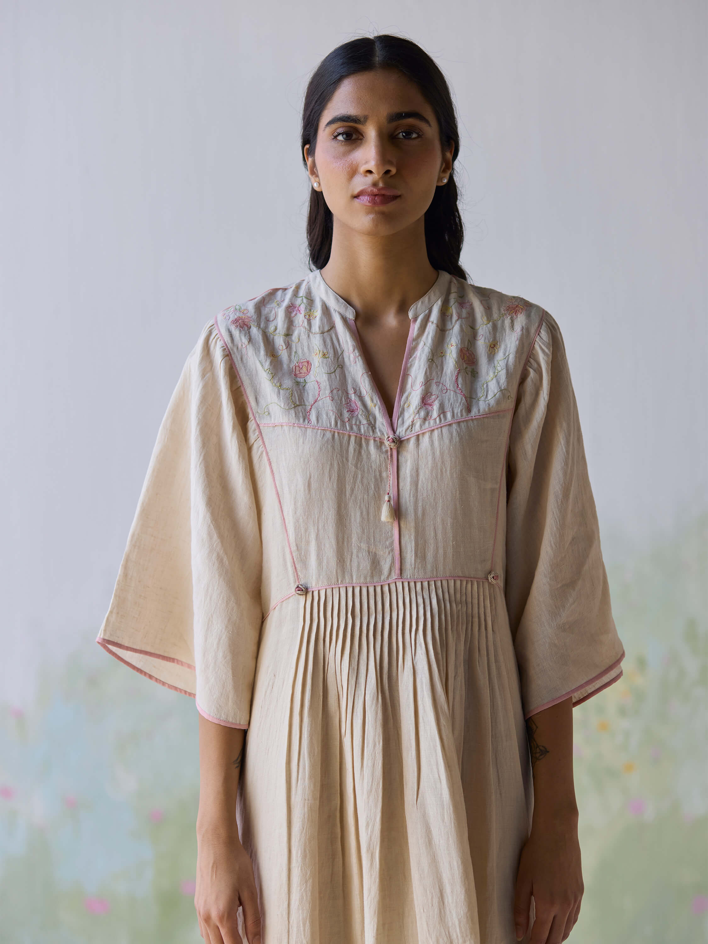 Sweetly embroidered kaftan dress worn by a model, showcasing elegant design.