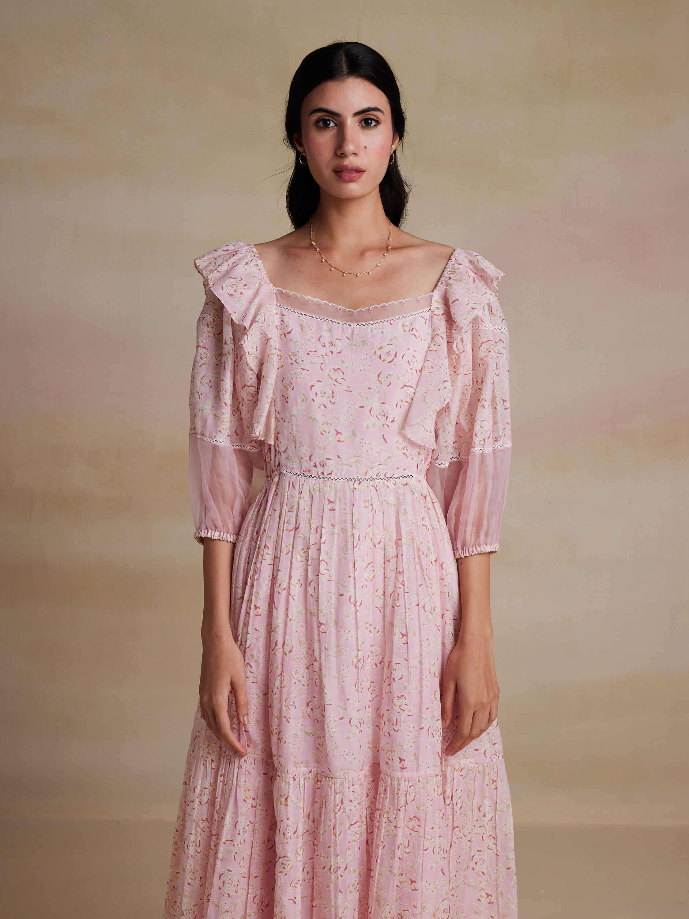 Elegant woman in vintage pink floral dress with ruffled sleeves
