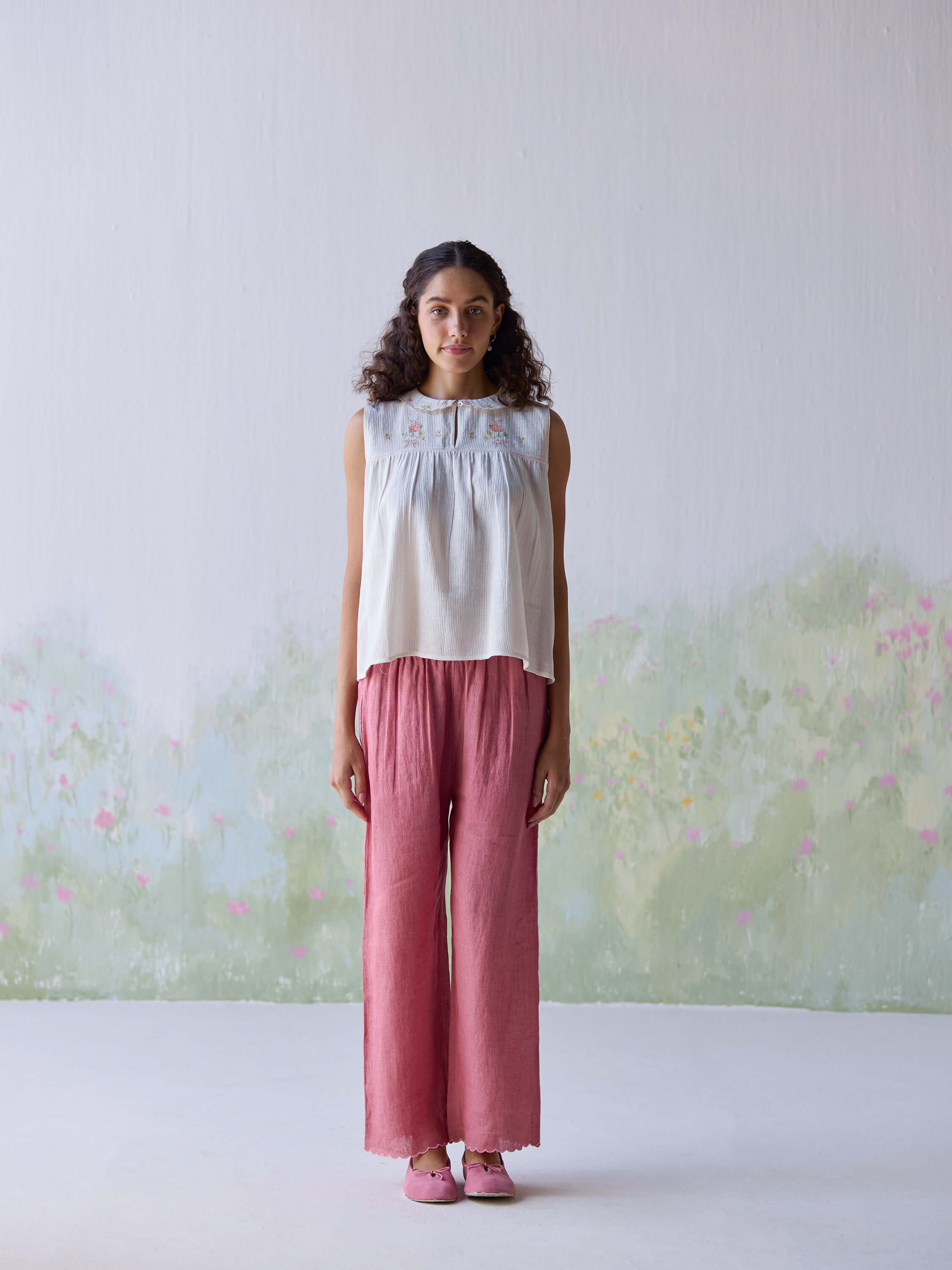Folk embroidered top styled with pink linen pants, casual summer fashion.