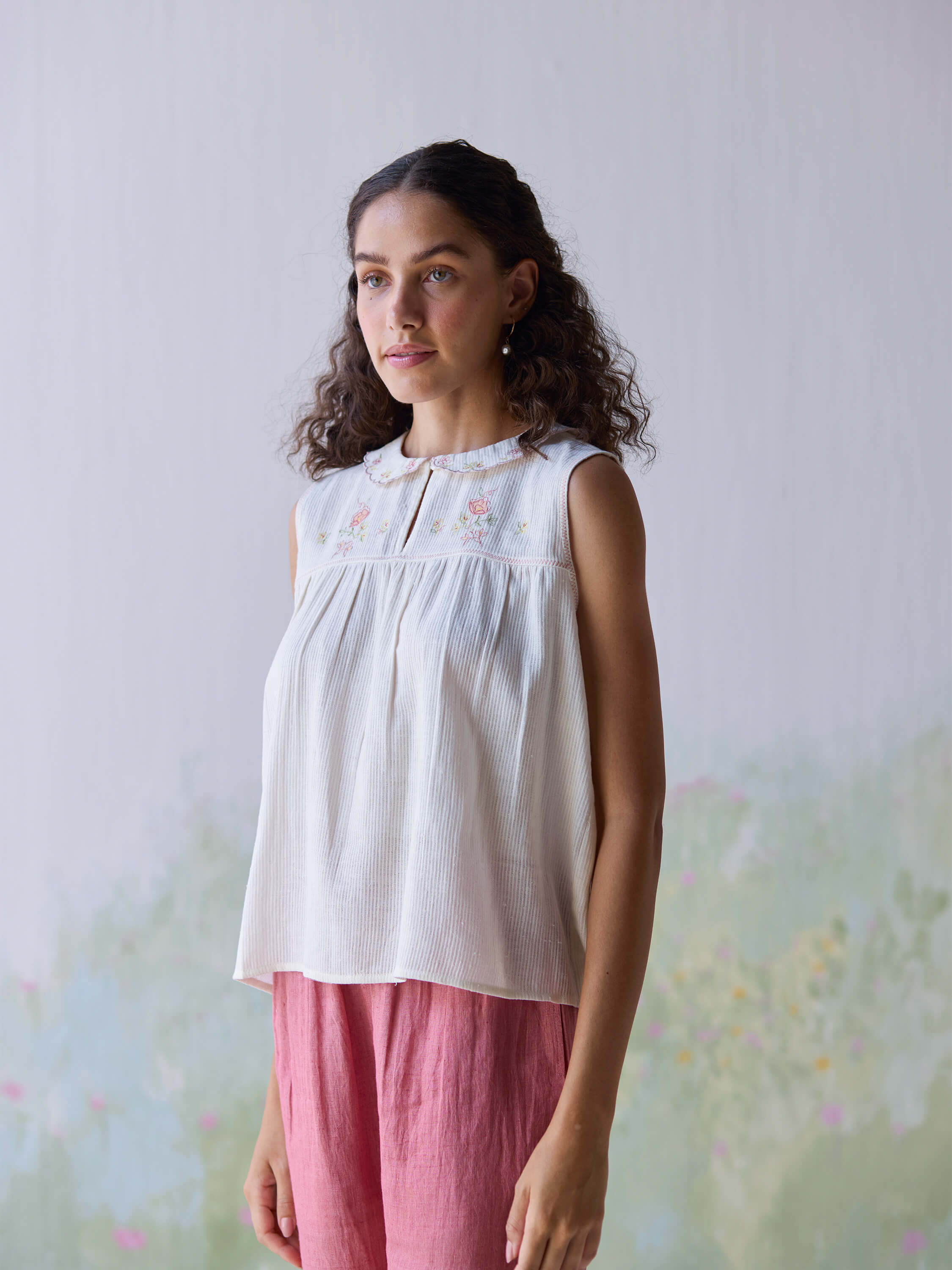 Folk embroidered top with delicate floral design and soft fabric.