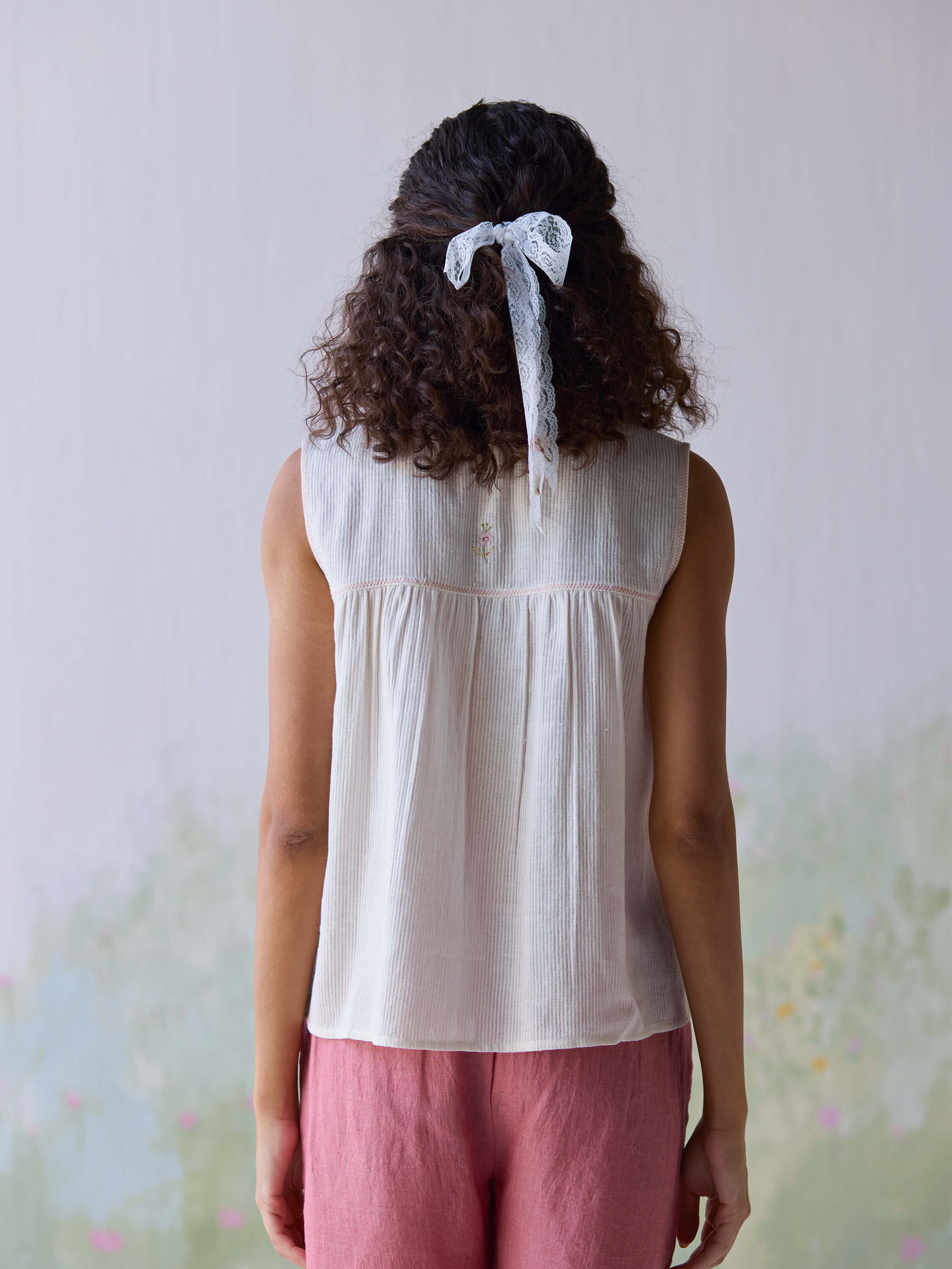 Back view of a woman wearing a Folk Embroidered Top.