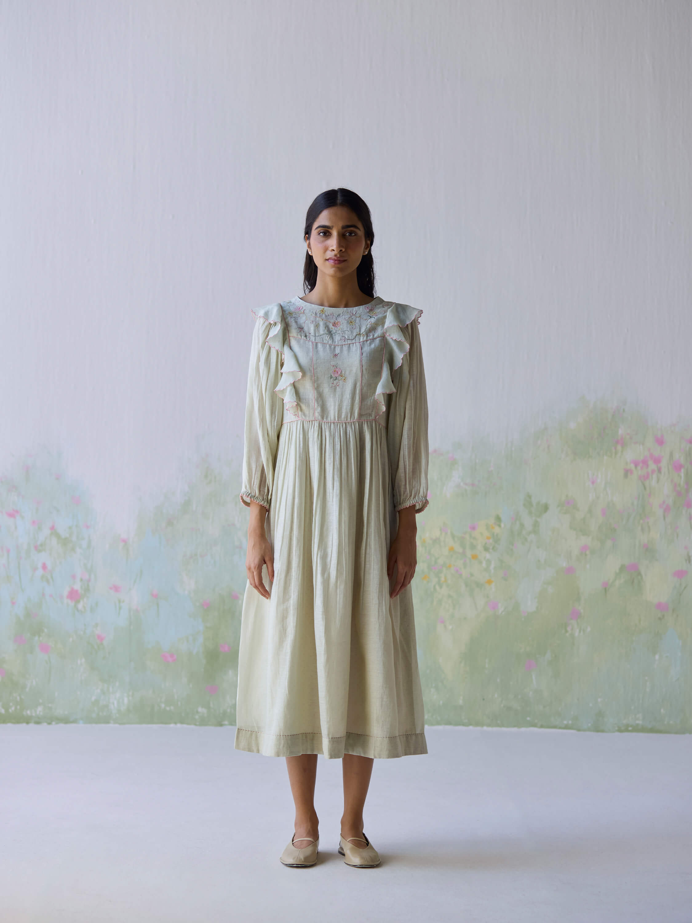 Elegant model in Sound of Music Midi Dress with floral accents.