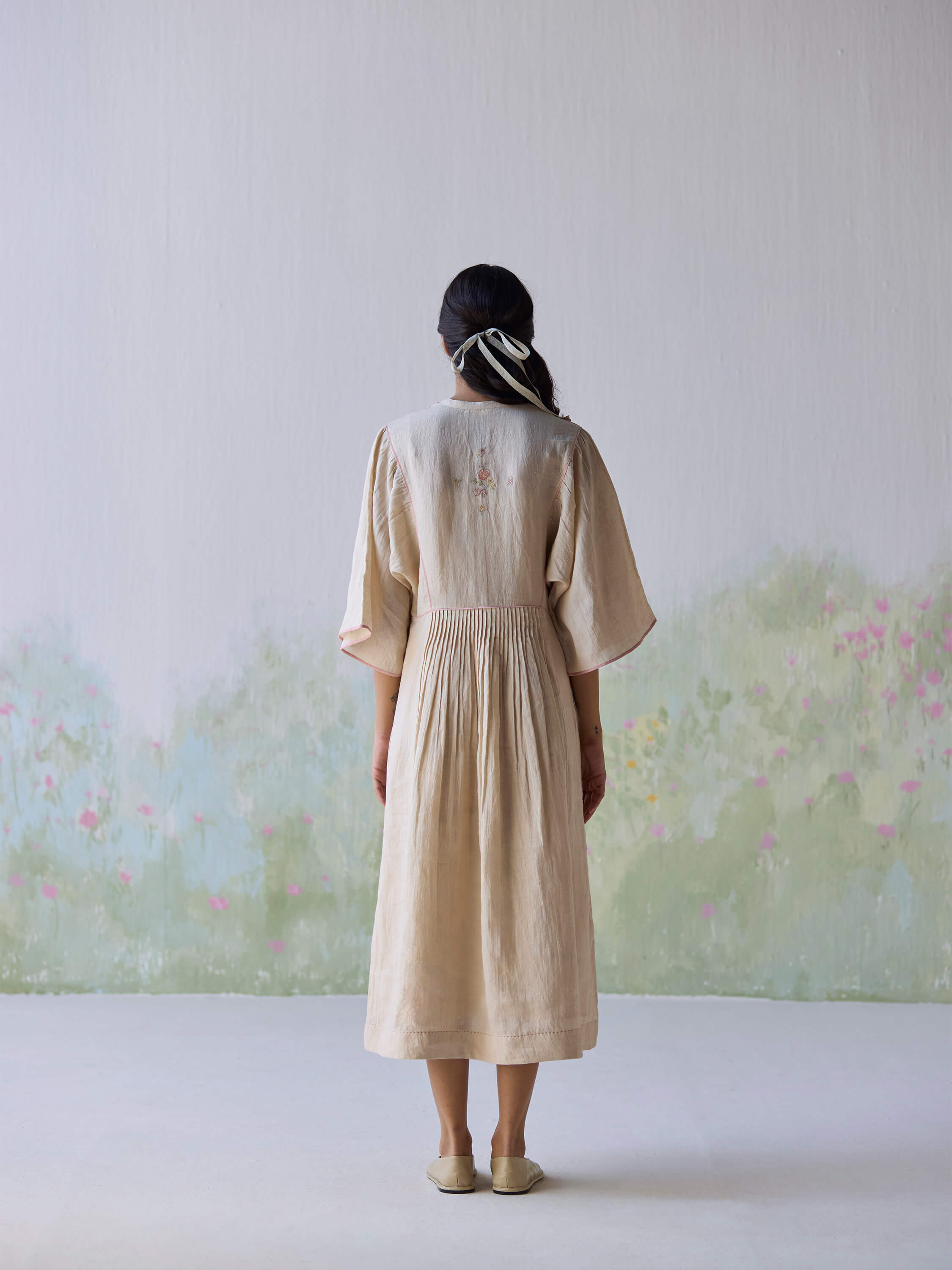 Elegant embroidered kaftan dress showcasing a soft, flowy design from behind.