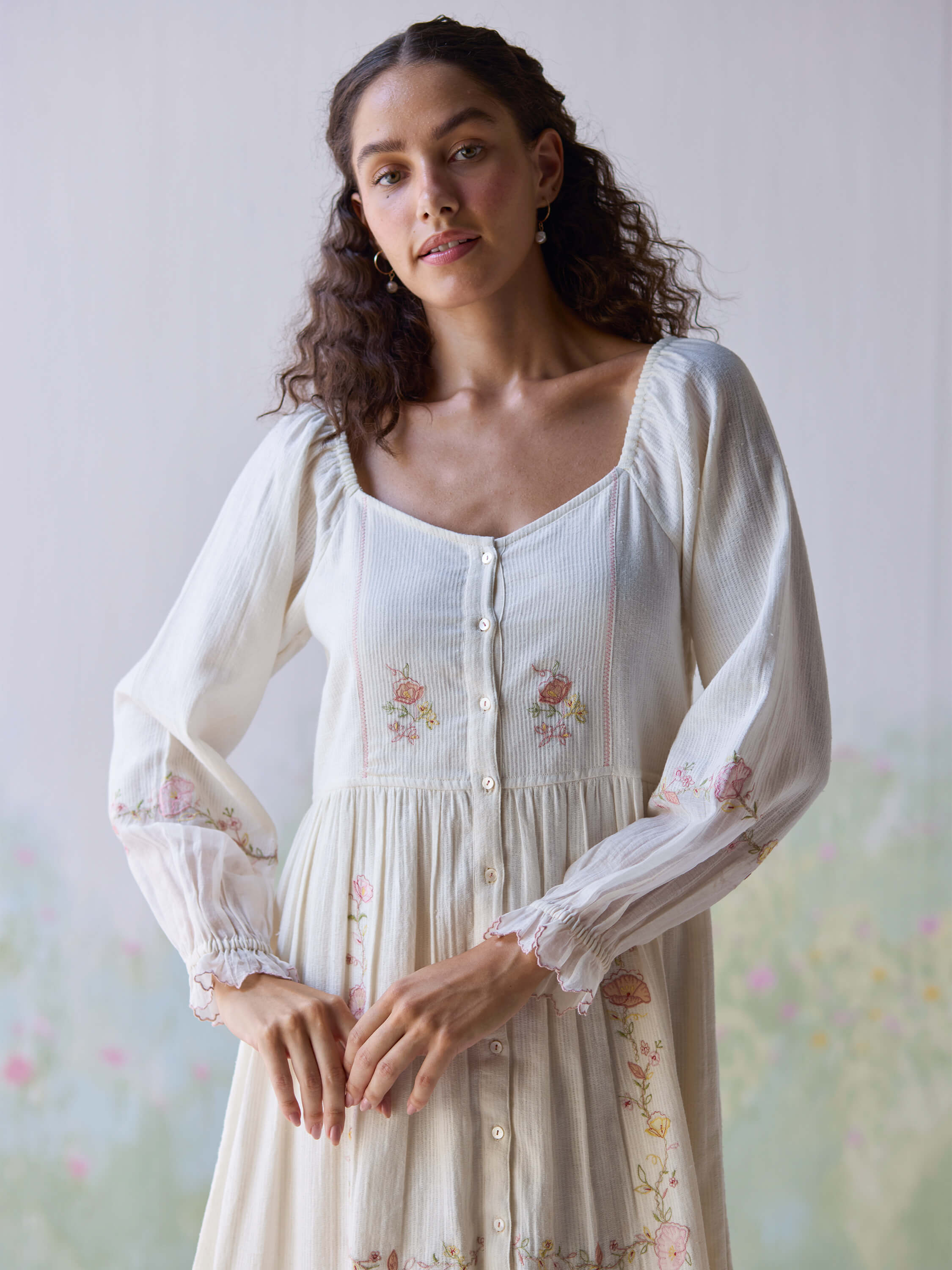 Model wearing Verona Midi Dress with floral embroidery details.