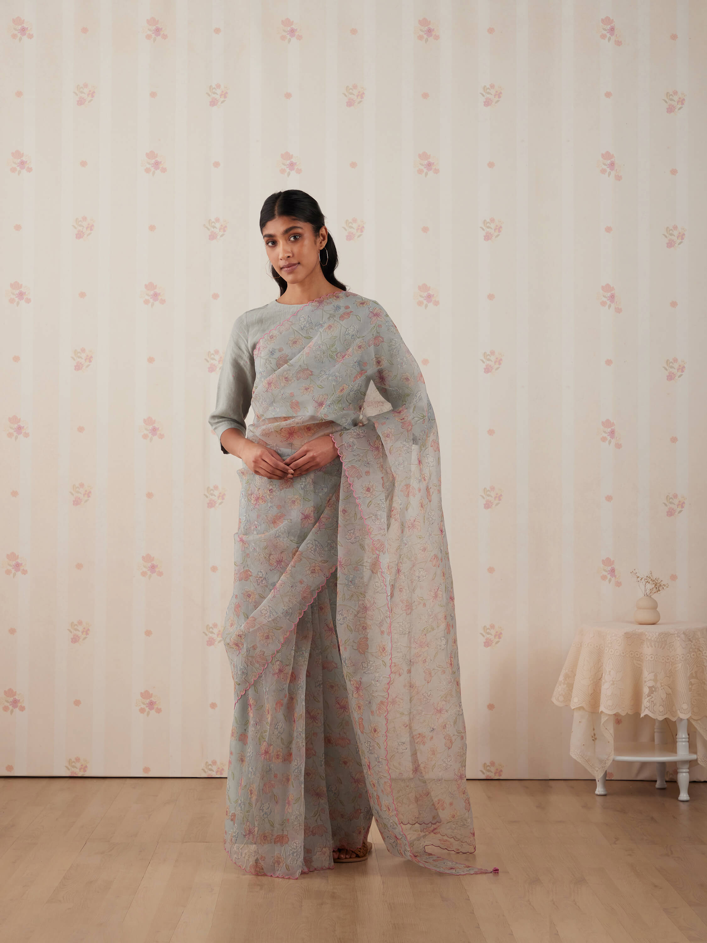 Woman wearing a floral saree with a matching blouse.
